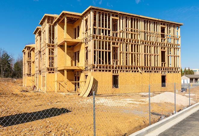 a temporary chain link fence locking away a building under renovation, serving as a security tool in Raymore